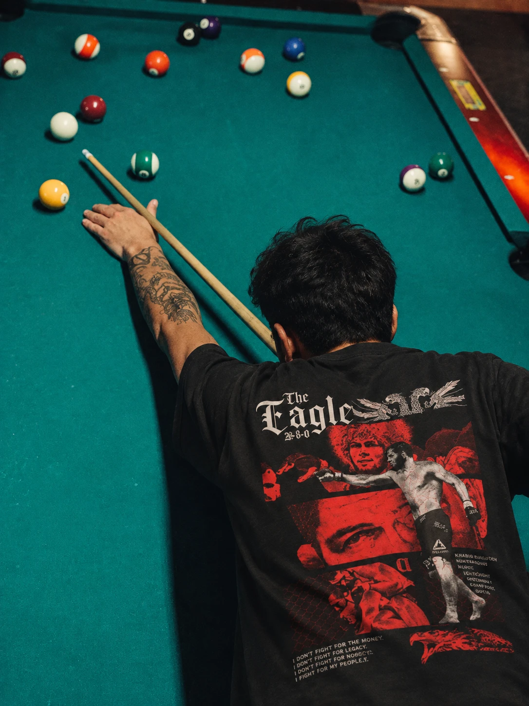 Fan playing pool in The Eagle back-print tee